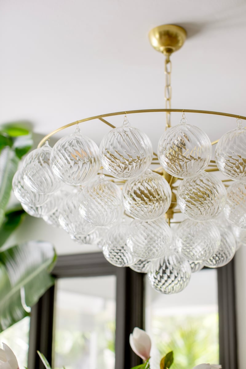 Aurora Chandelier Clear Glass Globe Aged Brass Elegant