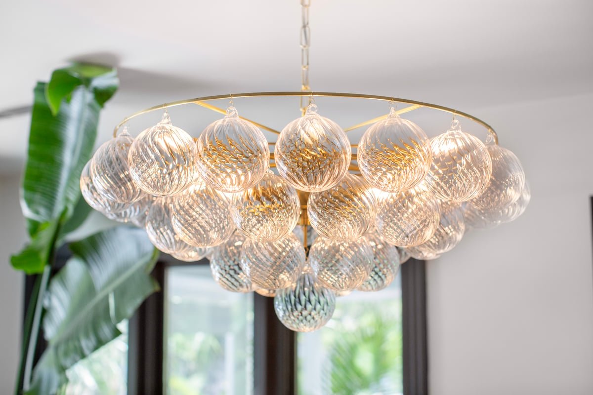Aurora Chandelier Clear Glass Globe Aged Brass Elegant
